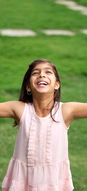 Children and teens - Happy girl smiling with open arms looking at the sky