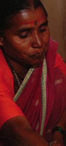 A woman lighting a smoke-less fire to cook food in rural India