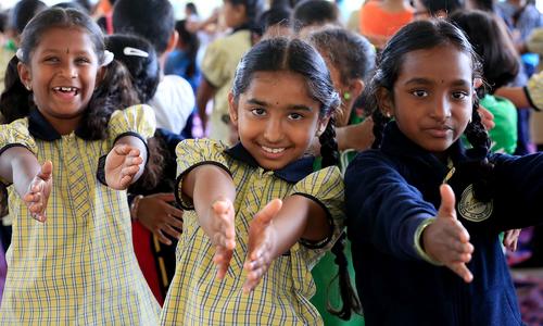 school students extending hands