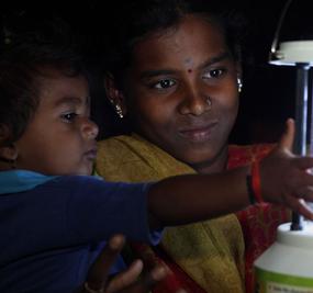 rural-electrification-village-women-and-child-with -lamp
